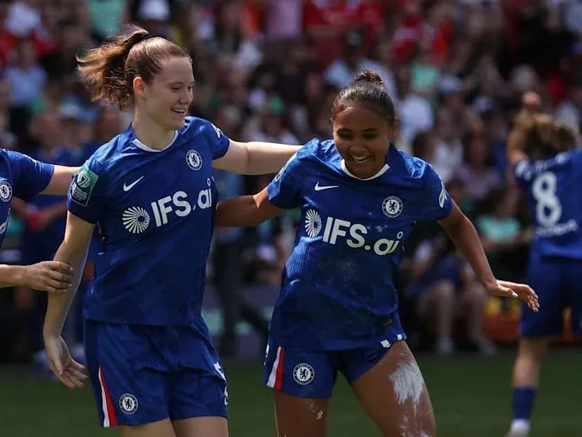 Chelsea players celebrating a goal on the pitch