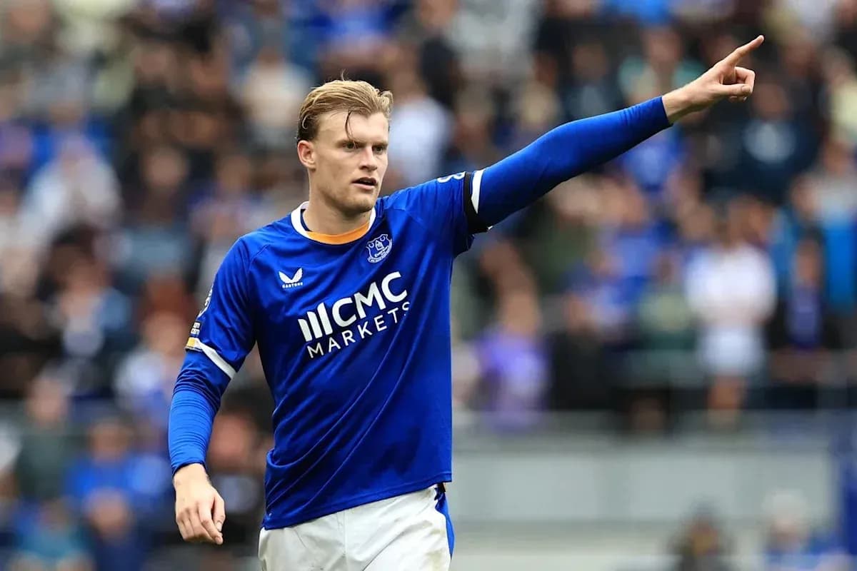 Player in blue jersey signaling during match