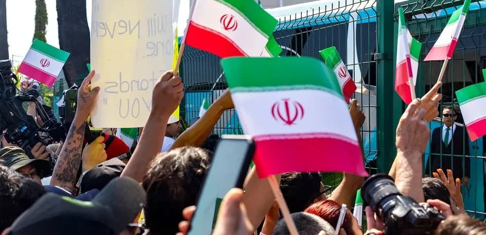 Crowd waving Iranian flags at a protest