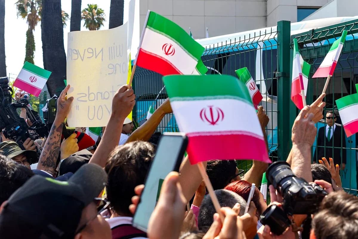 Crowd waving Iranian flags at a protest