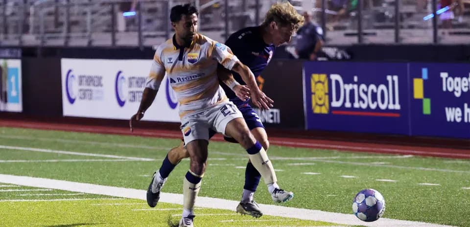 One Knoxville player dribbling the ball