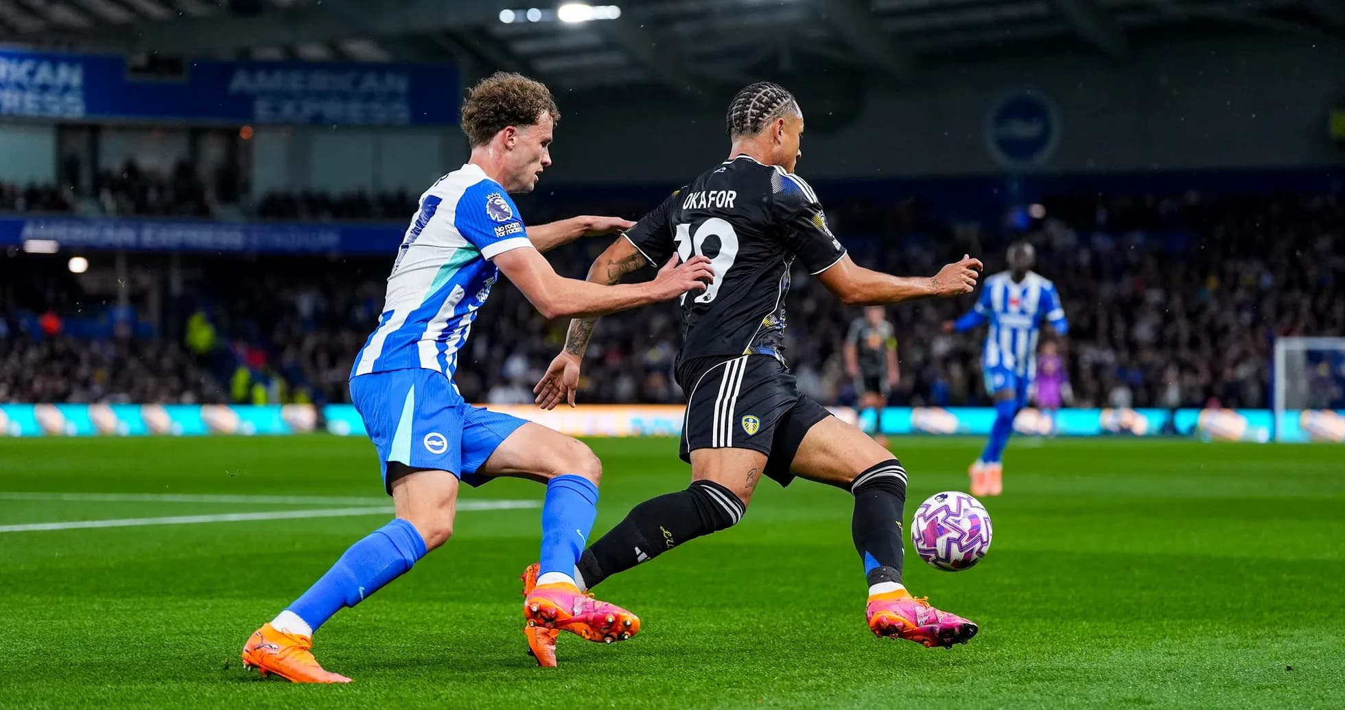 Leeds player dribbling past Brighton defender