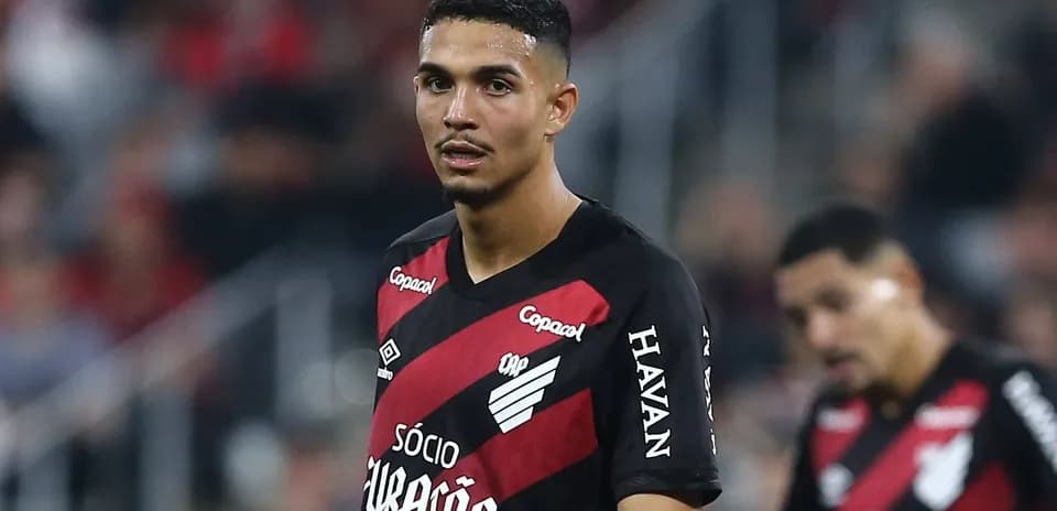 Player wearing red and black jersey on field