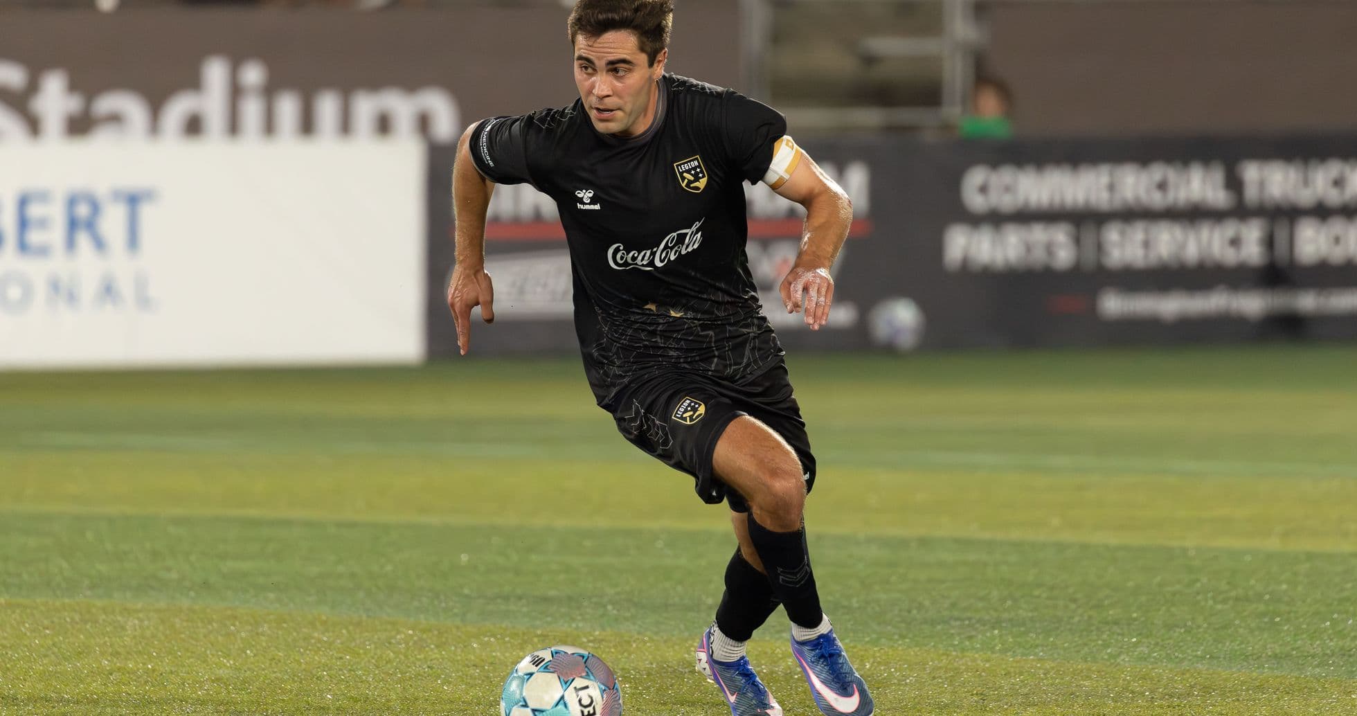 Player running with ball during football match