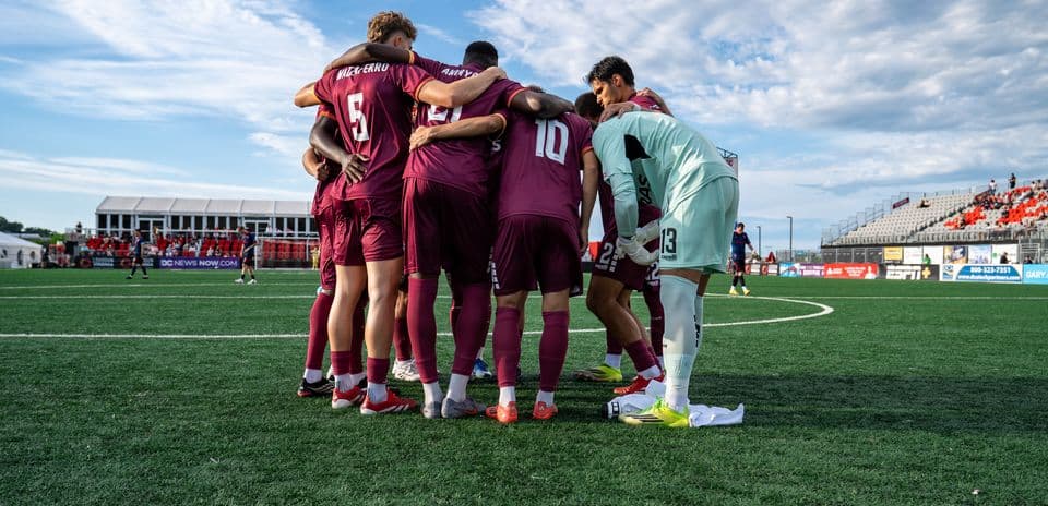Players huddled before the match
