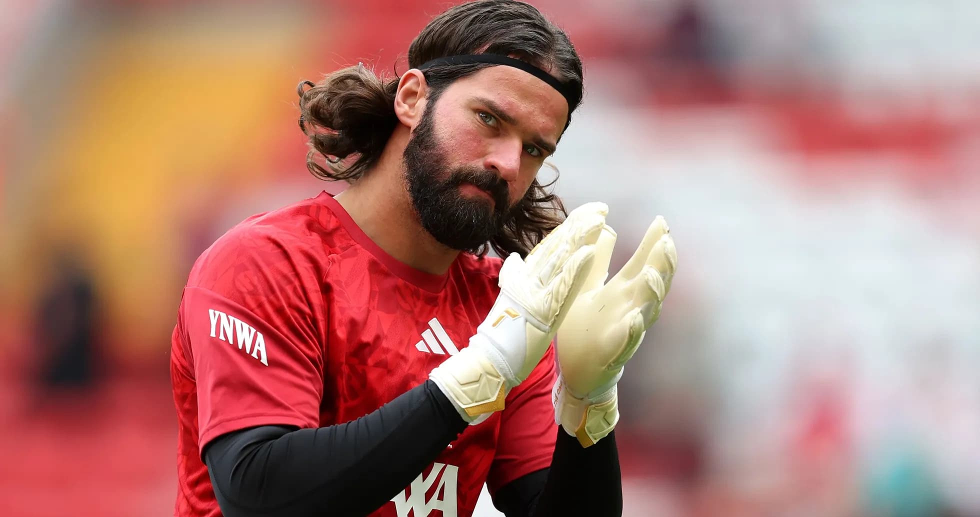 Goalkeeper clapping hands in warm-up attire