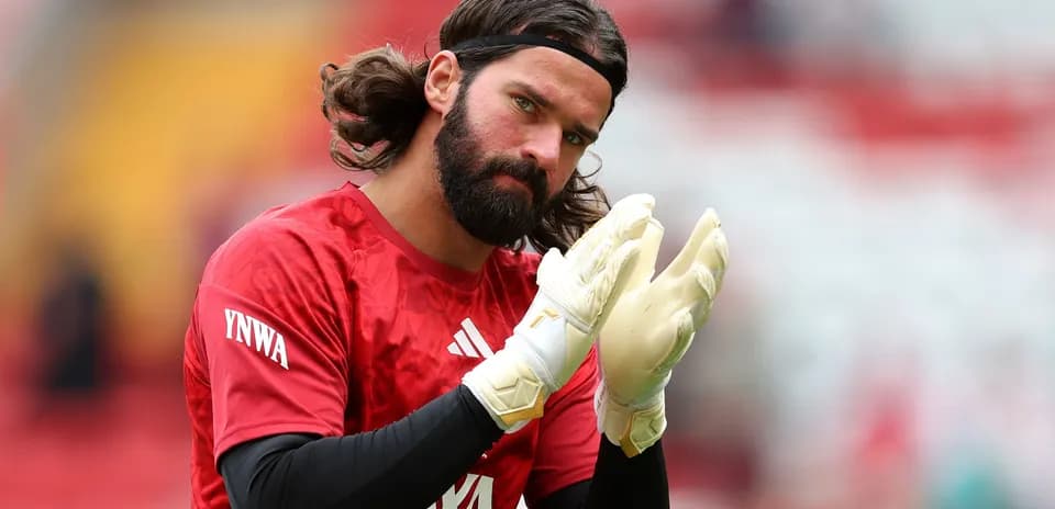 Goalkeeper clapping hands in warm-up attire