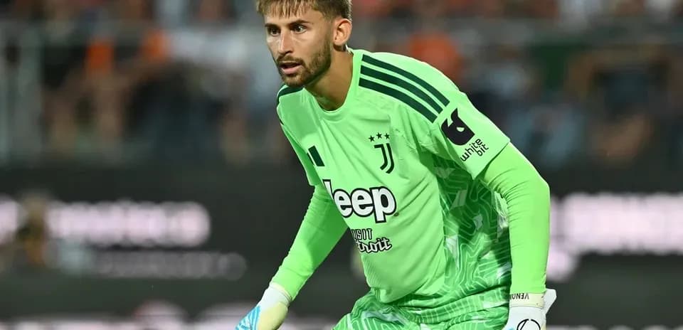 Goalkeeper in green jersey preparing for play