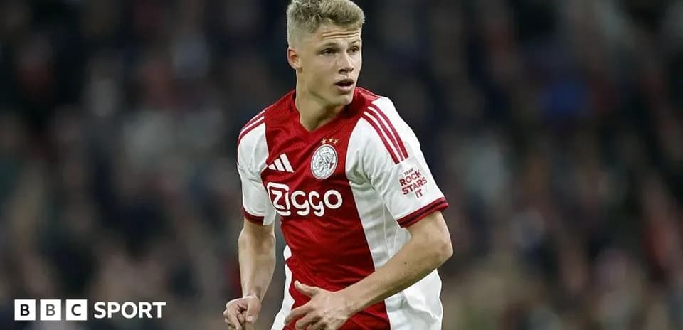 Player in Ajax kit running on the field