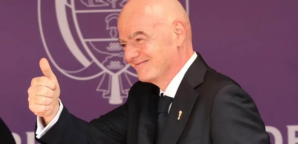 Man giving a thumbs up at event podium