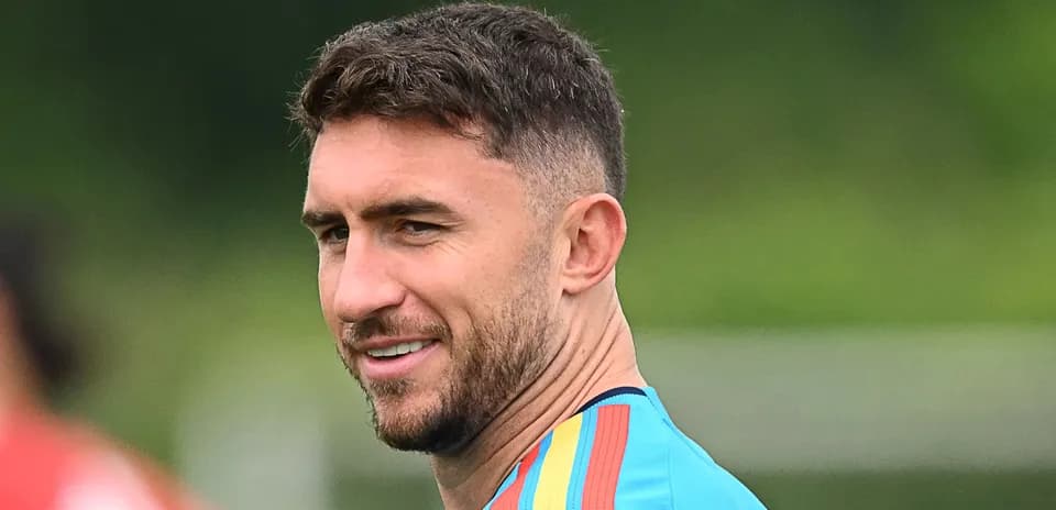 Football player in training attire smiling outdoors