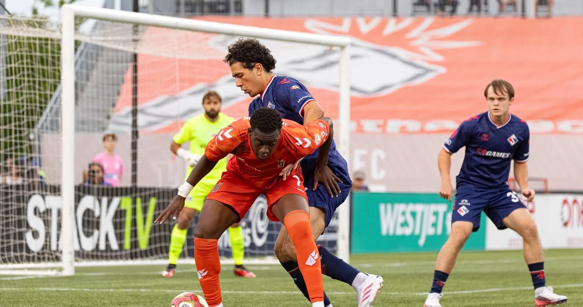 Players competing for the ball in match action