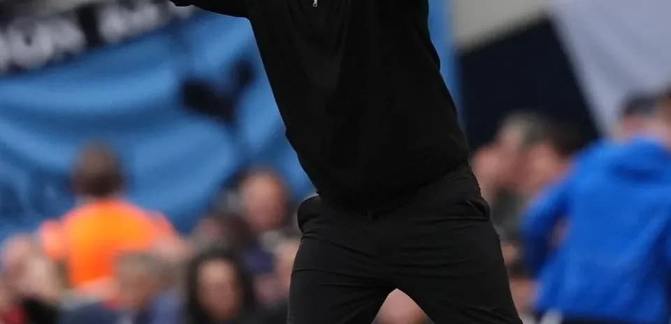 Coach directing players from the sideline during match