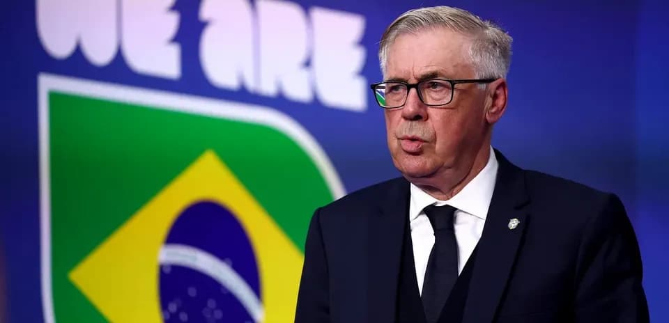 Man speaking at podium with Brazil flag backdrop