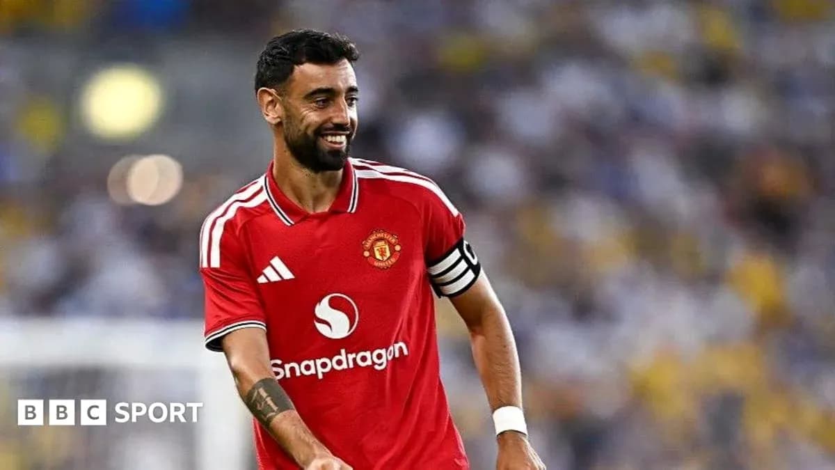 Bruno Fernandes smiling in Manchester United kit