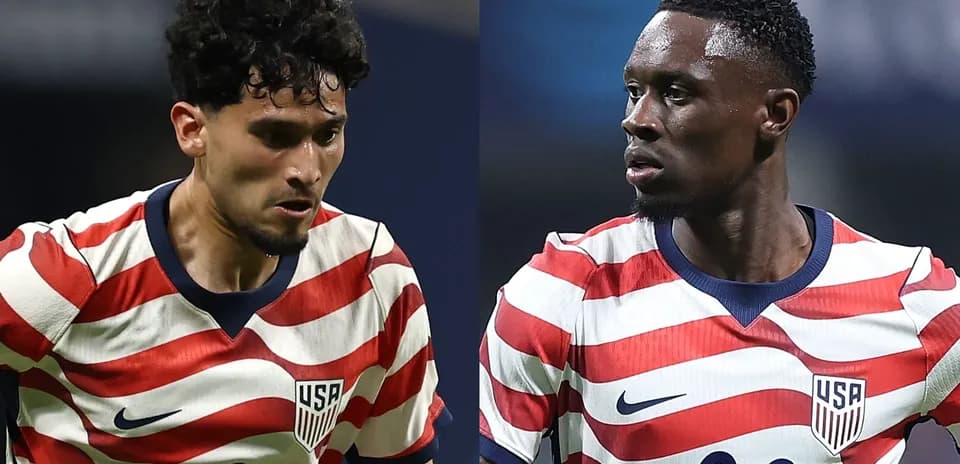 Two USA players in striped jerseys during match
