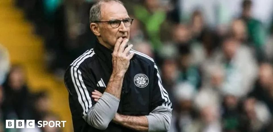 Manager observing the match with thoughtful expression