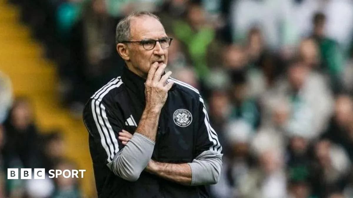 Manager observing the match with thoughtful expression
