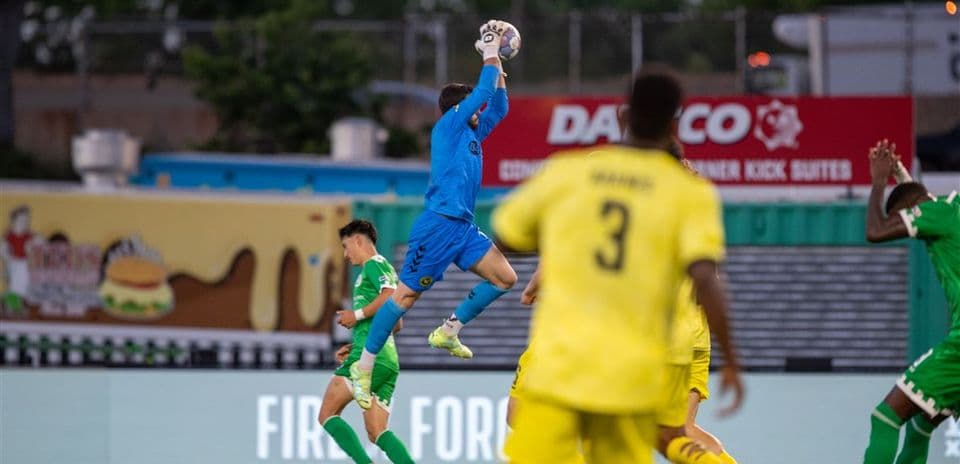 Goalkeeper catching the ball during match action