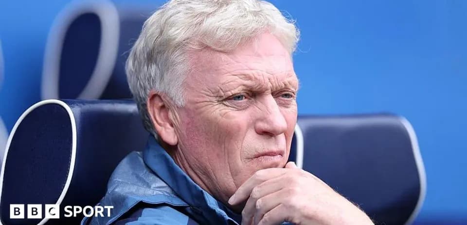 Coach seated on bench during a match