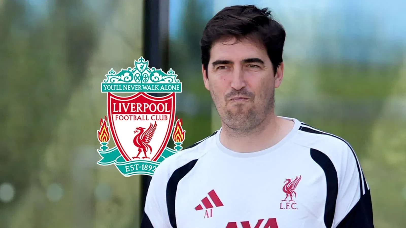 Coach wearing Liverpool FC training gear outdoors