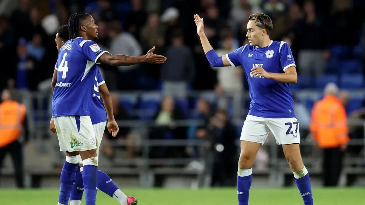 Two Cardiff City players celebrating on the pitch