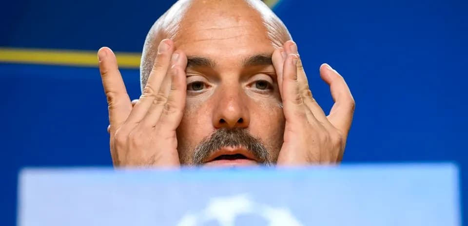Coach gesturing during a press conference appearance