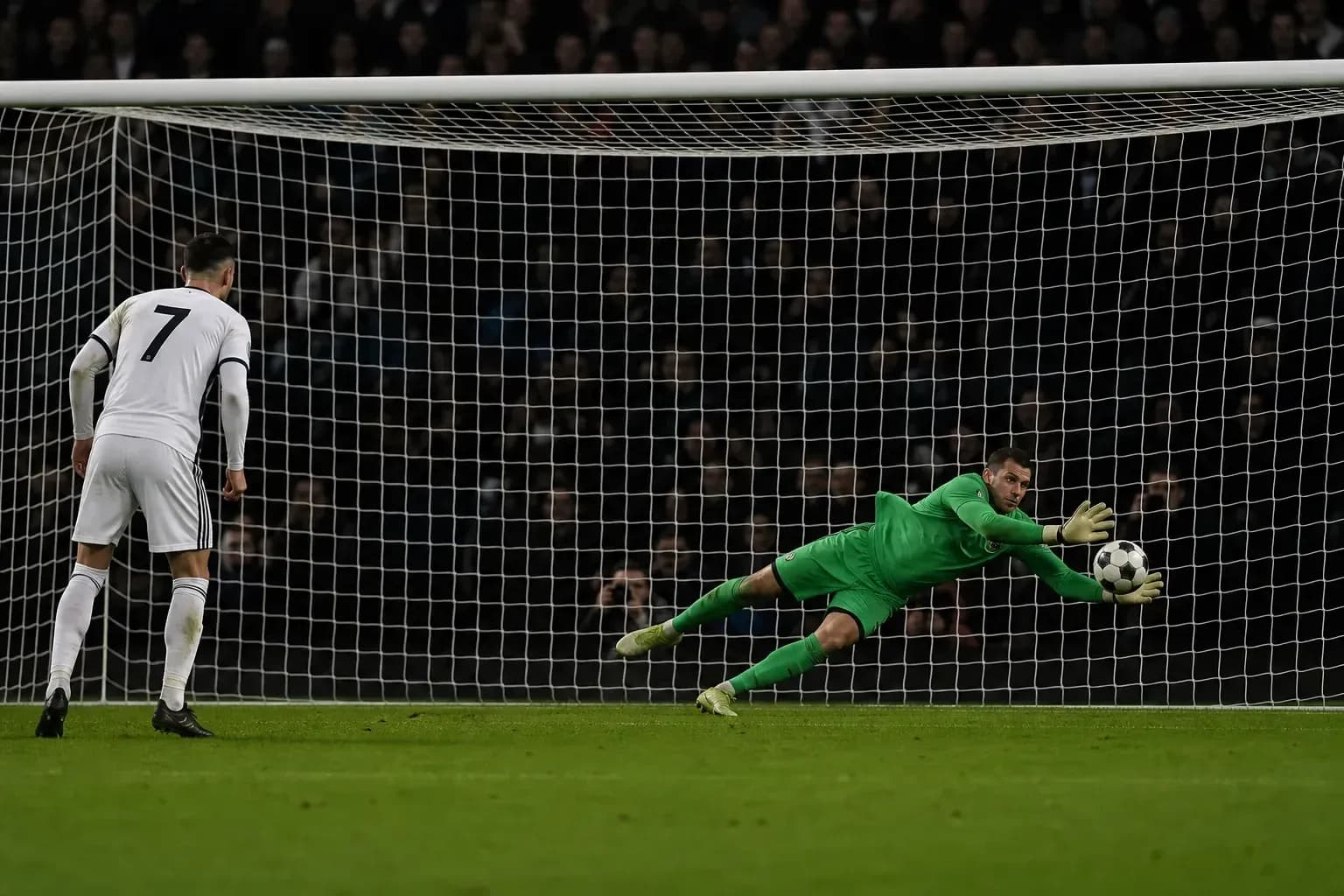 Goalkeeper saving a penalty kick during match