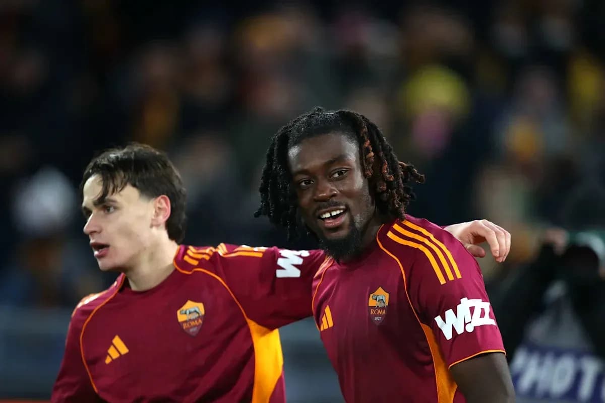 Two AS Roma players celebrating on the field