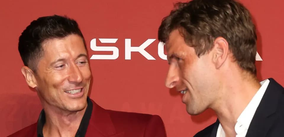 Two football players conversing at an awards event