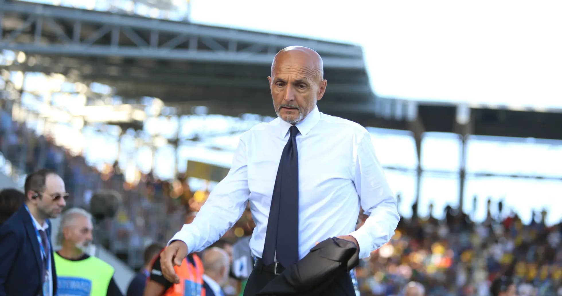 Coach walking along the sidelines during match