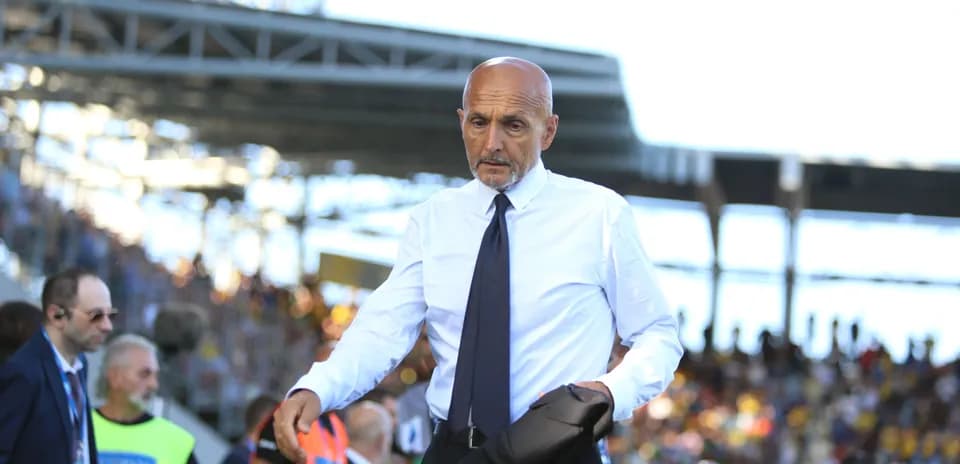 Coach walking along the sidelines during match