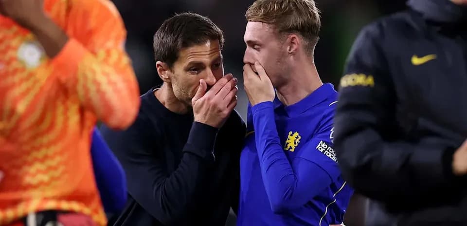 Coach speaking with player after the match