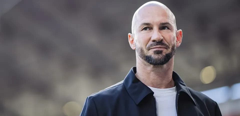 Man in black jacket with beard and shaved head