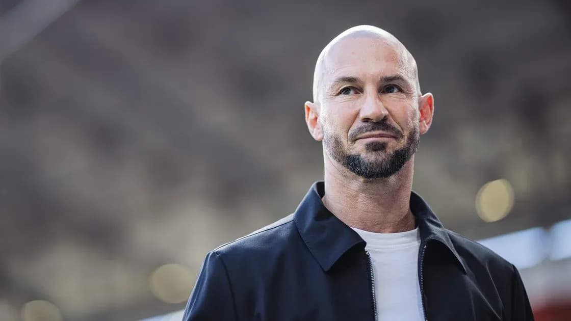 Man in black jacket with beard and shaved head