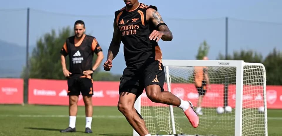 Player training with a soccer ball on pitch
