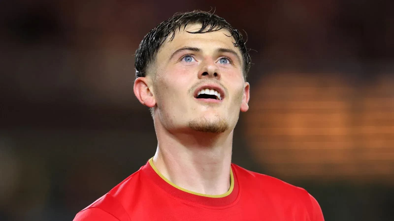 Player in red jersey looking up during match