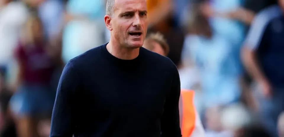 Coach directing players during a match on the sidelines