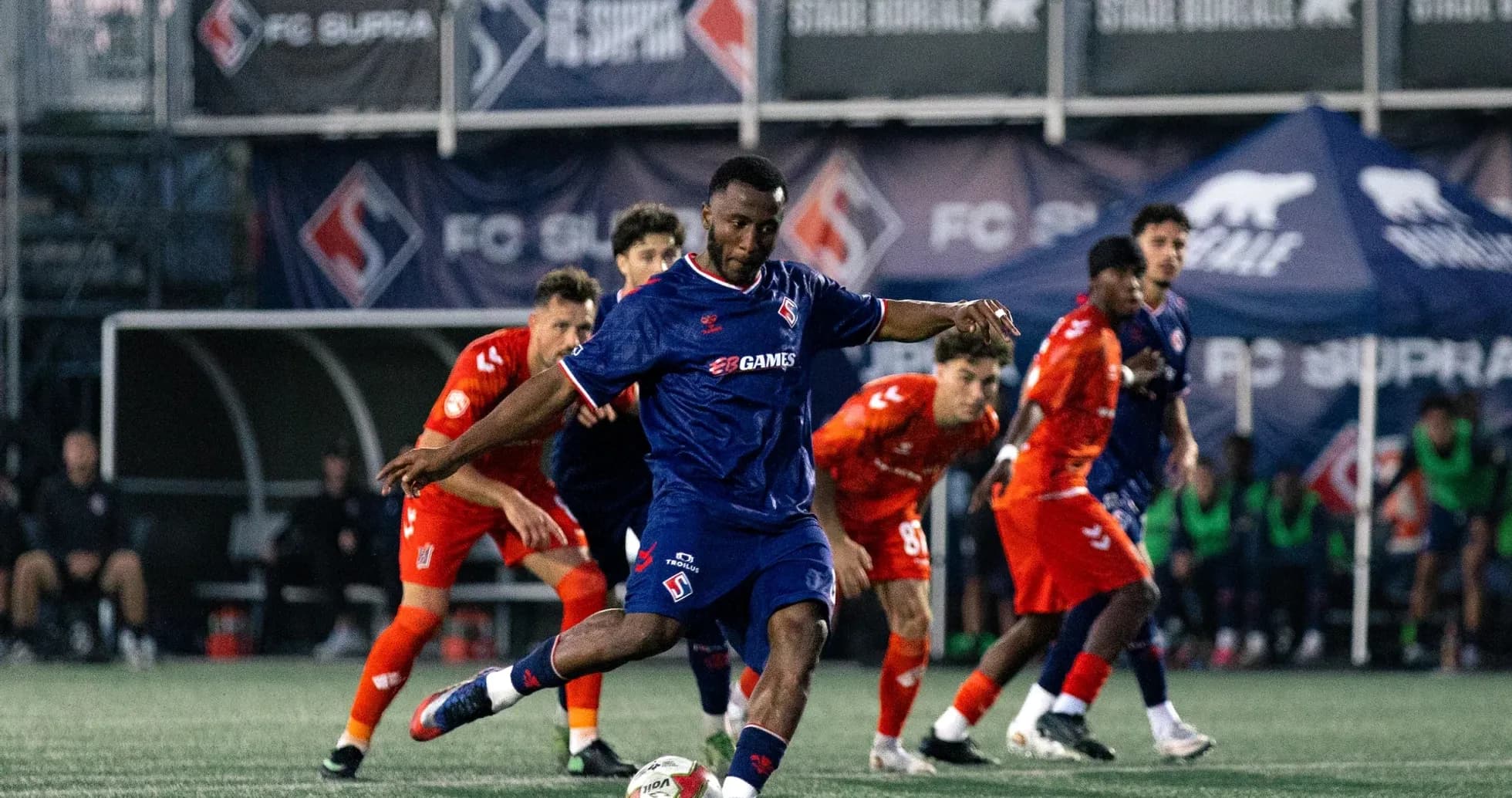 Player kicking the ball during FC Supra match