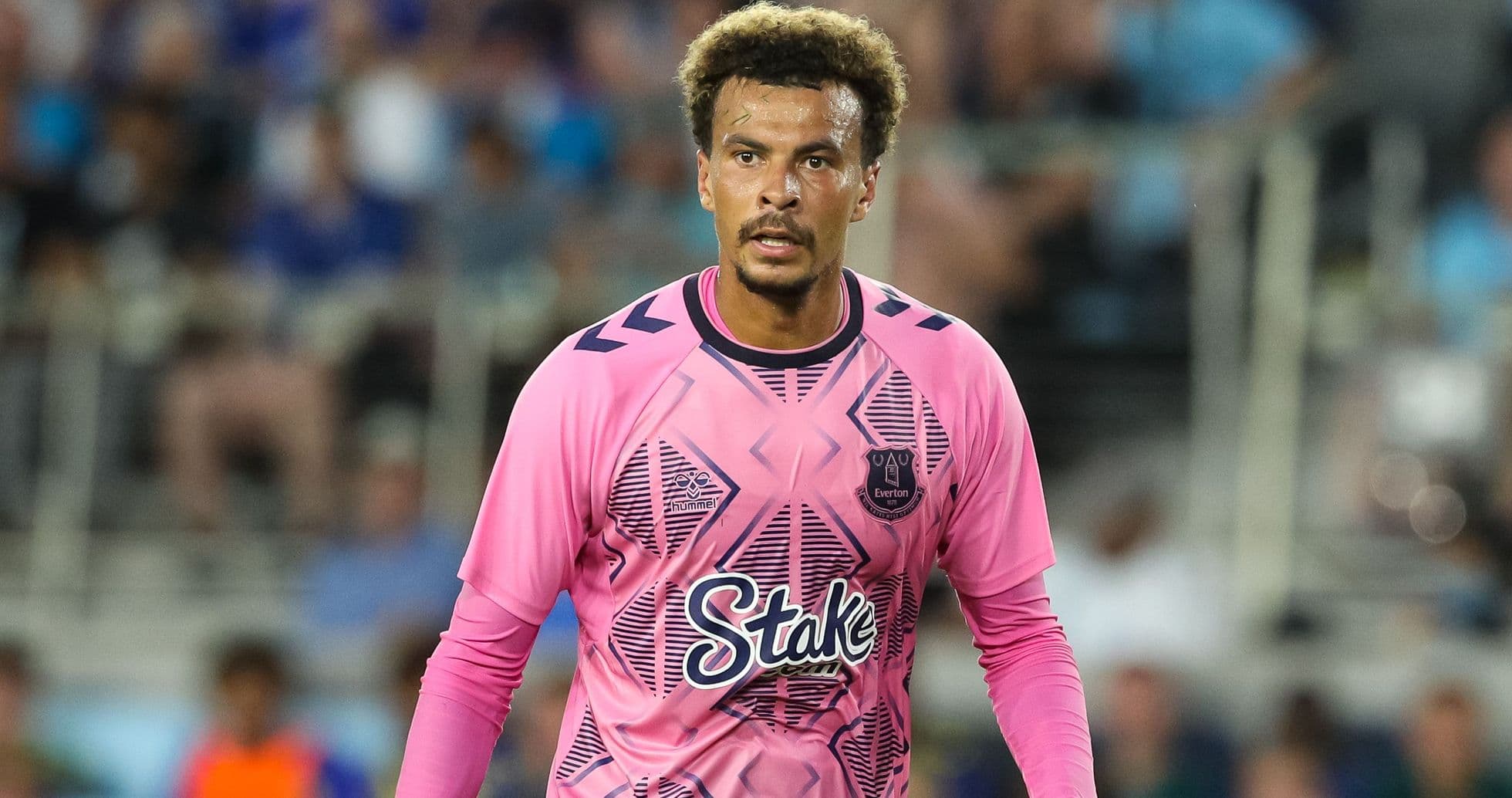 Goalkeeper in pink kit during match action