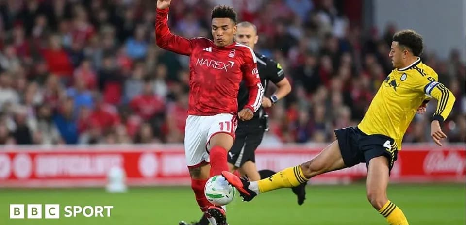 Player in red dribbling past opponent in yellow