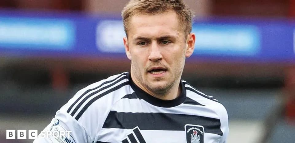 Player wearing black and white striped jersey on field