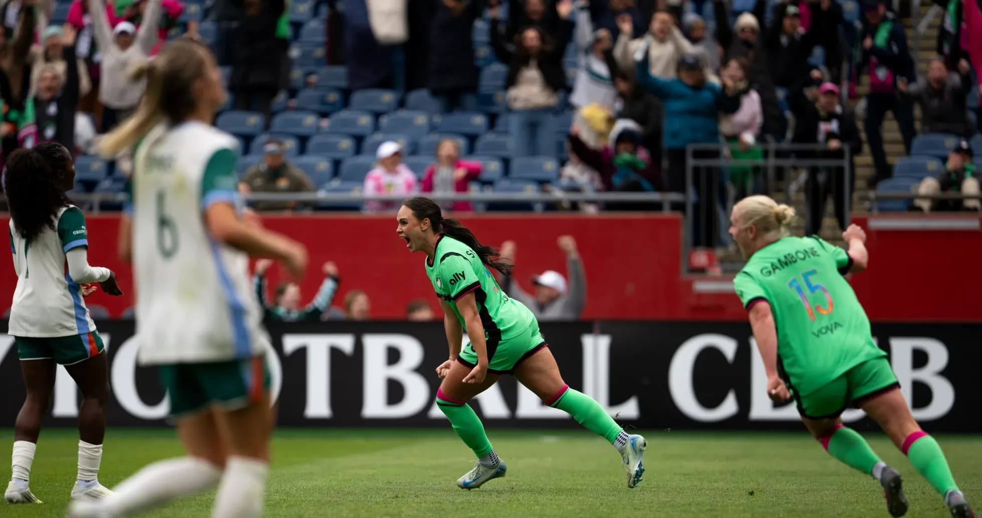 Players celebrating a goal during NWSL match