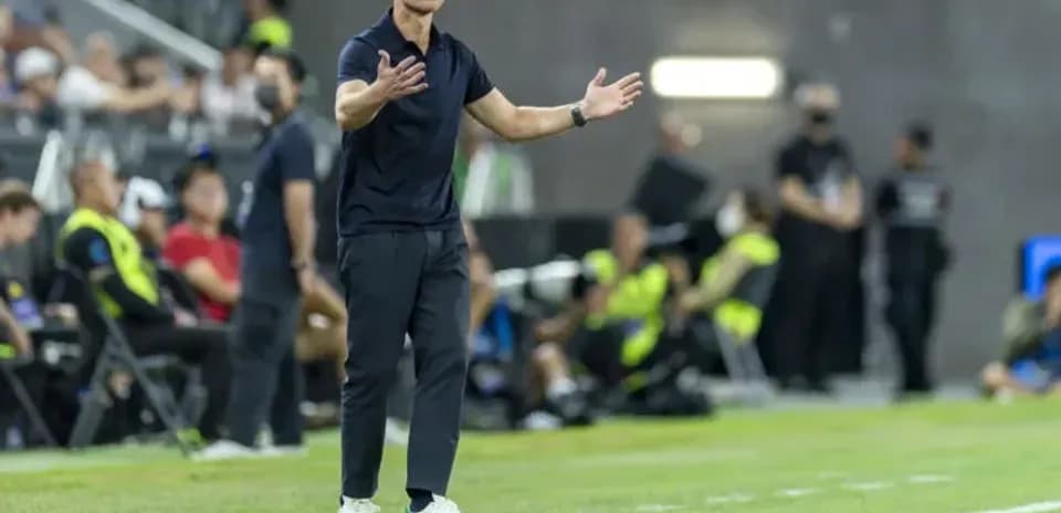 Coach gesturing on the sideline during match