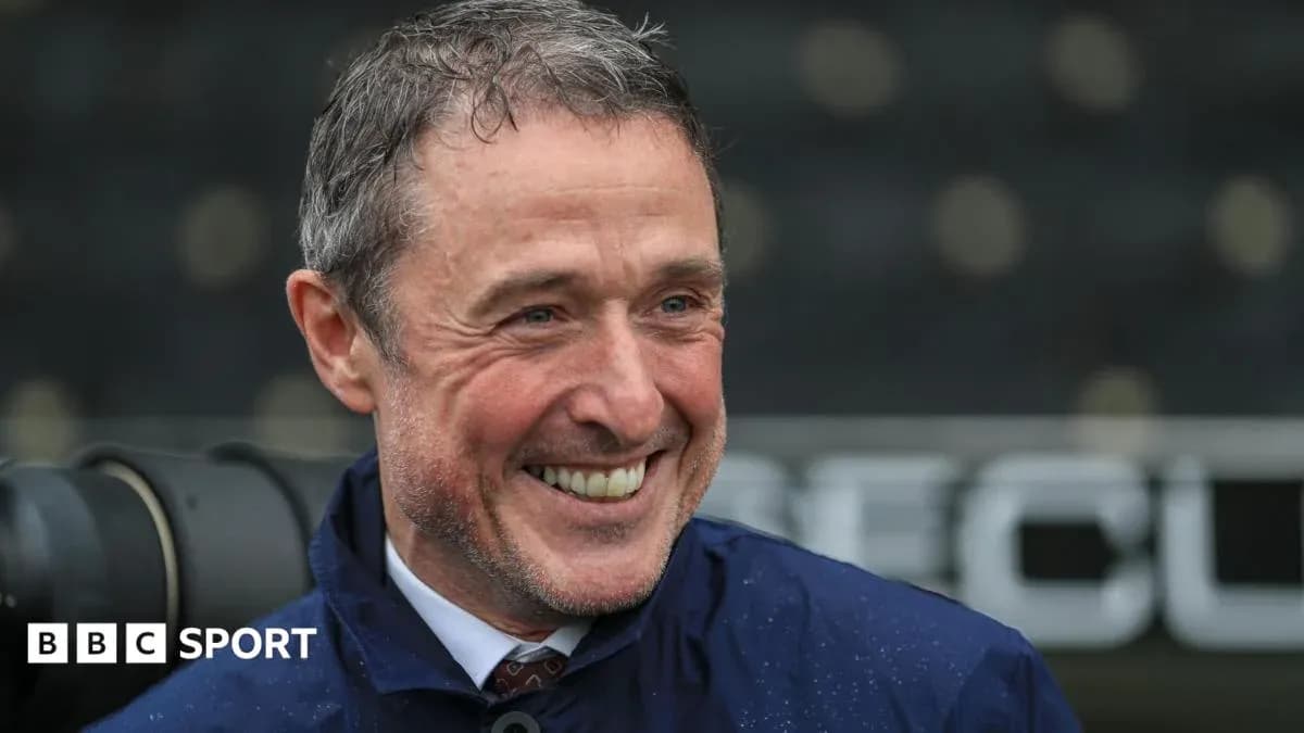 Man smiling during a press conference outdoors