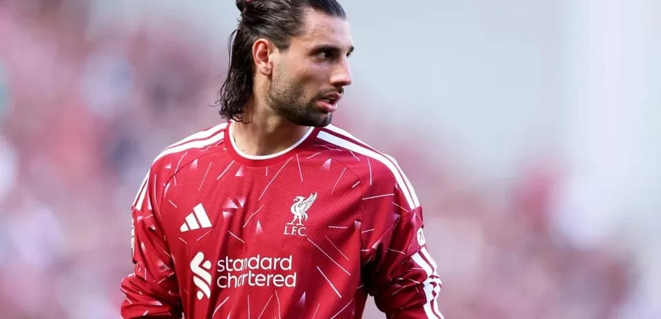 Goalkeeper wearing Liverpool kit during match