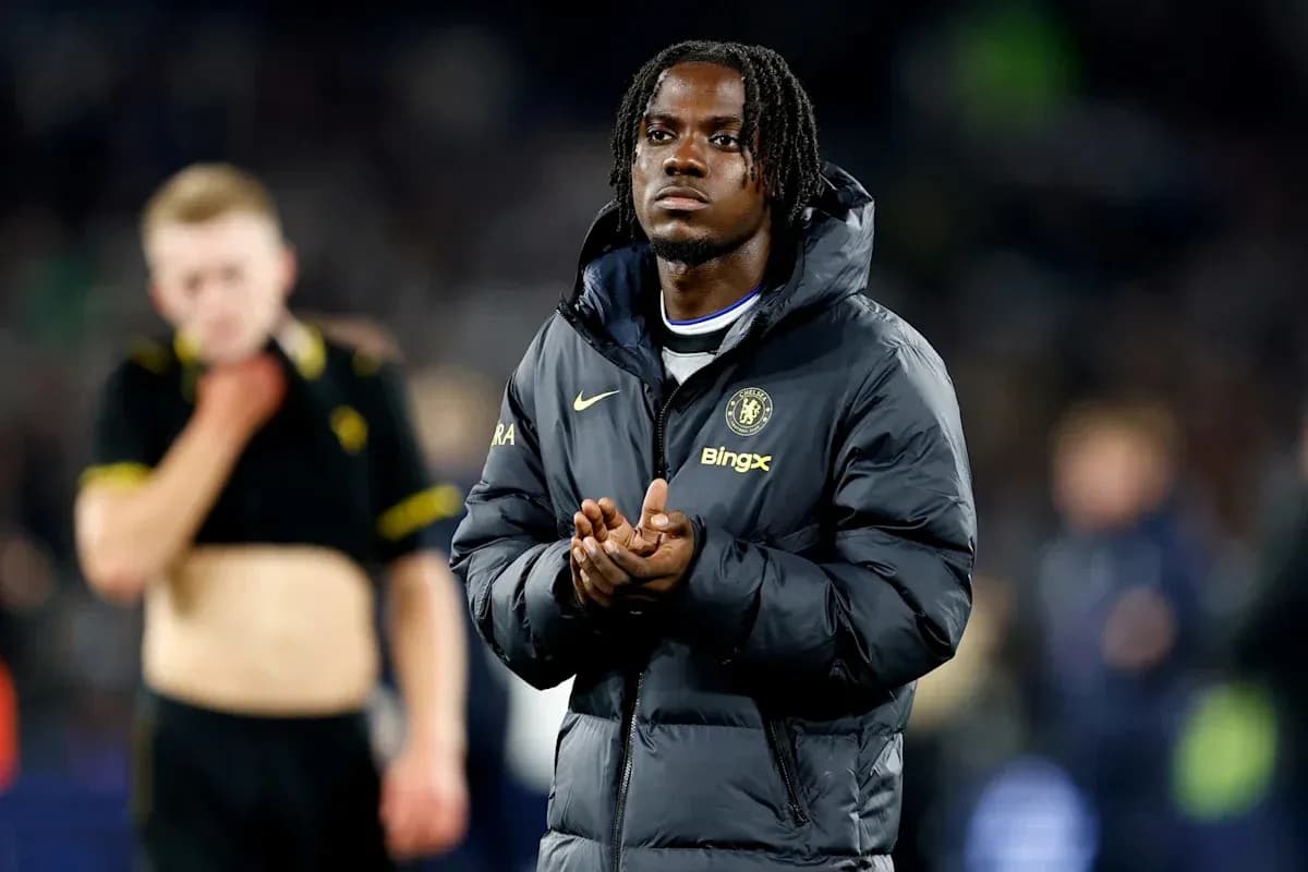 Player in Chelsea jacket applauding after match