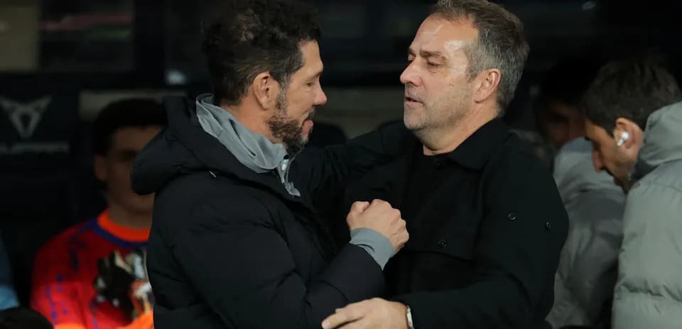 Two coaches greeting each other before the match