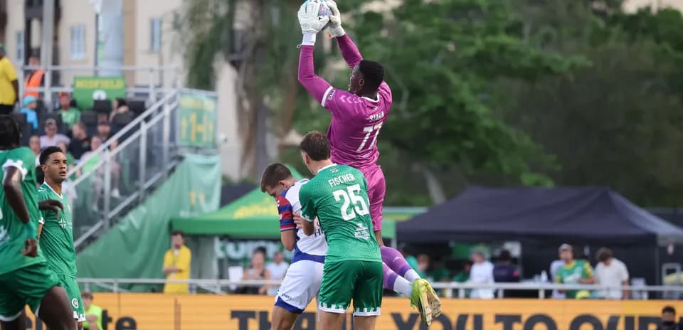 Goalkeeper catching the ball during match action