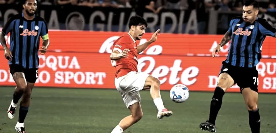 Player kicking the ball during football match action